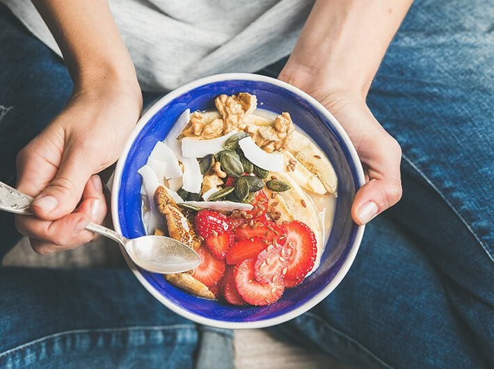 A person sitting with a healthy detox diet plate.